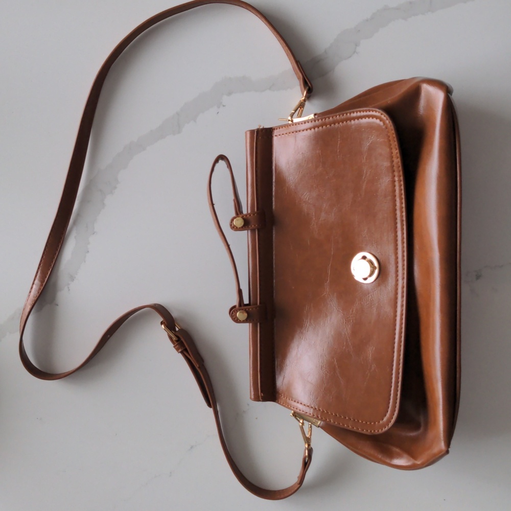 Brown faux leather purse with gold-coloured clasp detail and accents
